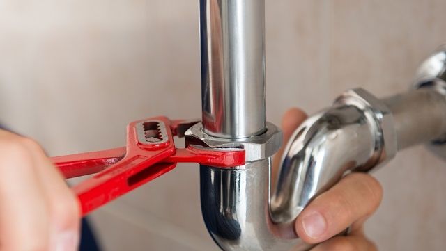 Our plumbers repairing a bathroom pipe 